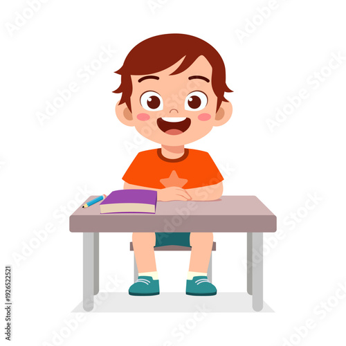 A happy smiling little boy student character sitting at school desk with a book and pencil