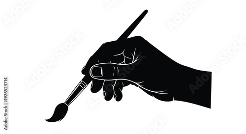 A silhouetted hand delicately holding a paintbrush poised for artistic creation