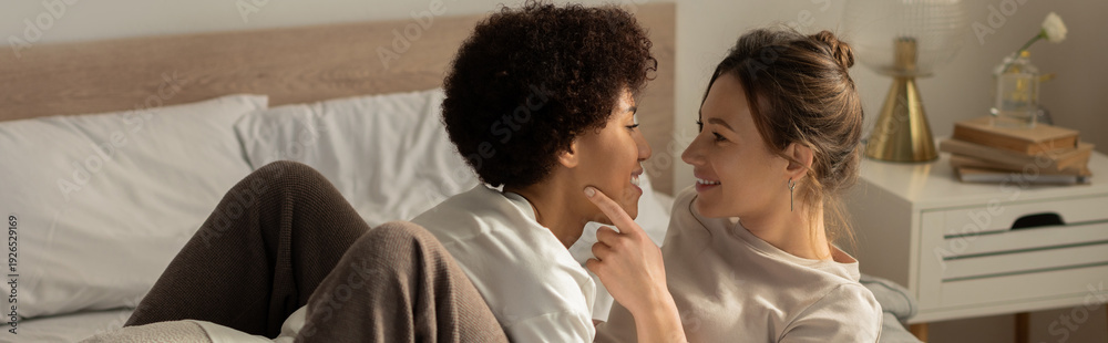 Naklejka premium Loving couple sharing a joyful moment in their cozy bedroom together