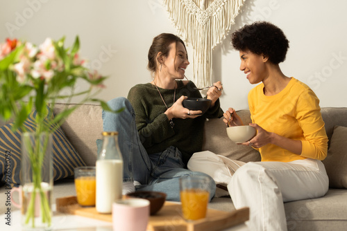 Quadro em tela Joyful moments shared by a loving lesbian couple enjoying breakfast together at