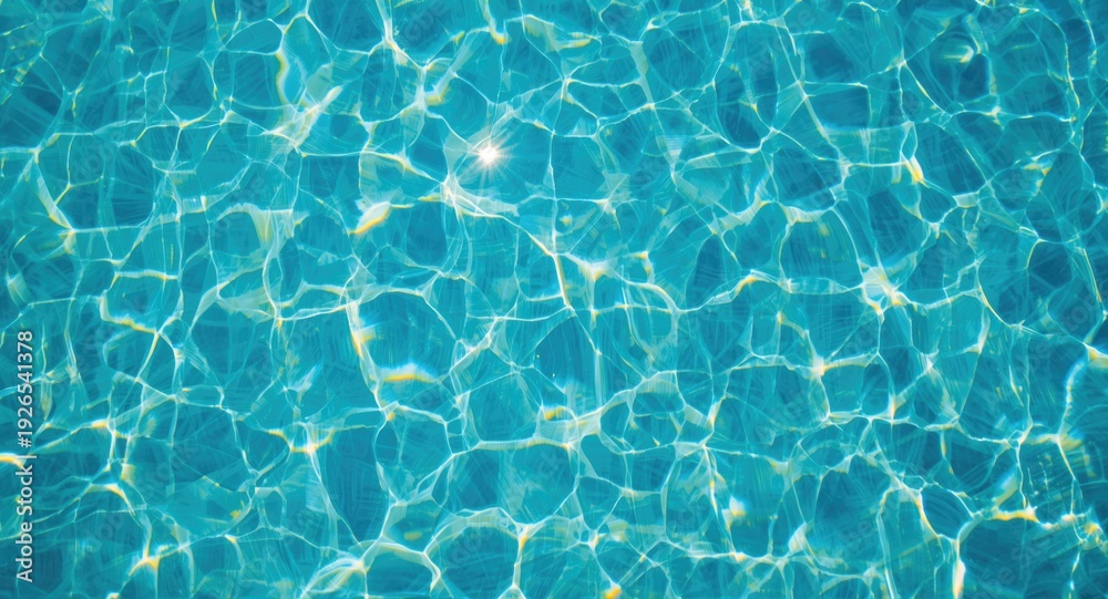 Obraz premium Sunlit blue pool water with a visible tiled floor captured from above in a summery ambiance