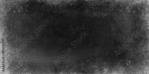 A dark and black and white grunge background features an empty vintage concrete wall texture with a dirty, aged grey paper pattern on a blank chalkboard surface backdrop