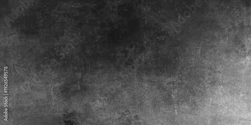 A dark aged concrete wall texture provides a vintage grey grunge backdrop with a dirty rough surface design for an old blank paper wallpaper pattern
