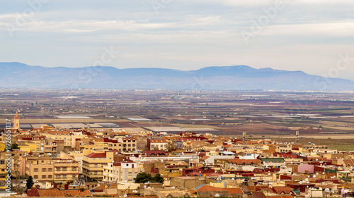 Εκτύπωση καμβά Panoramic View of Moroccan Cityscape with Atlas Mountains and Agricultural Field