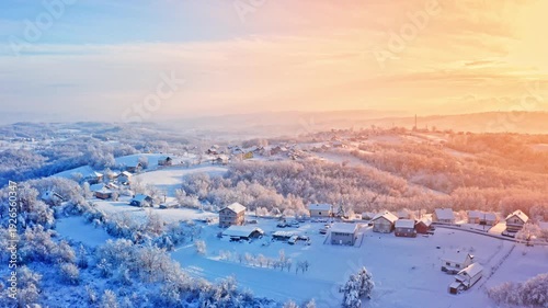 Winter sunrise over snowy countryside village