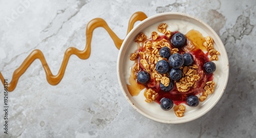 Wallpaper Mural Overhead perspective of a creamy yogurt bowl with granola clusters, fresh blueberries, and maple syrup drizzled over a light gray backdrop Torontodigital.ca