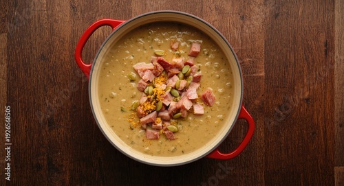 Wallpaper Mural Overhead close up of split pea soup with diced ham, mustard, and pumpkin seeds in red pot on textured dark wood Torontodigital.ca