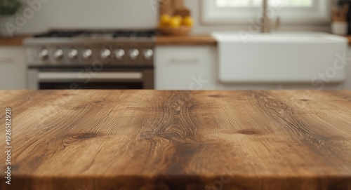 Rough textured wood table and an out of focus kitchen backdrop with electric stove and sink