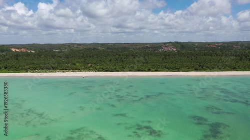 Fantiastic aerial view of calm beaches with natural swimming pools among the coral reefs of Milagres Route near Maceio City, Alagoas State, Brazil 