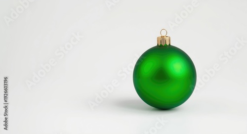 Vibrant green Christmas ornament set on plain white surface symbolizing holiday traditions