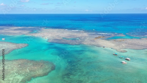 Φωτογραφία Wonderful view of white sand beach with turquoise waters and coral reefs in Mila