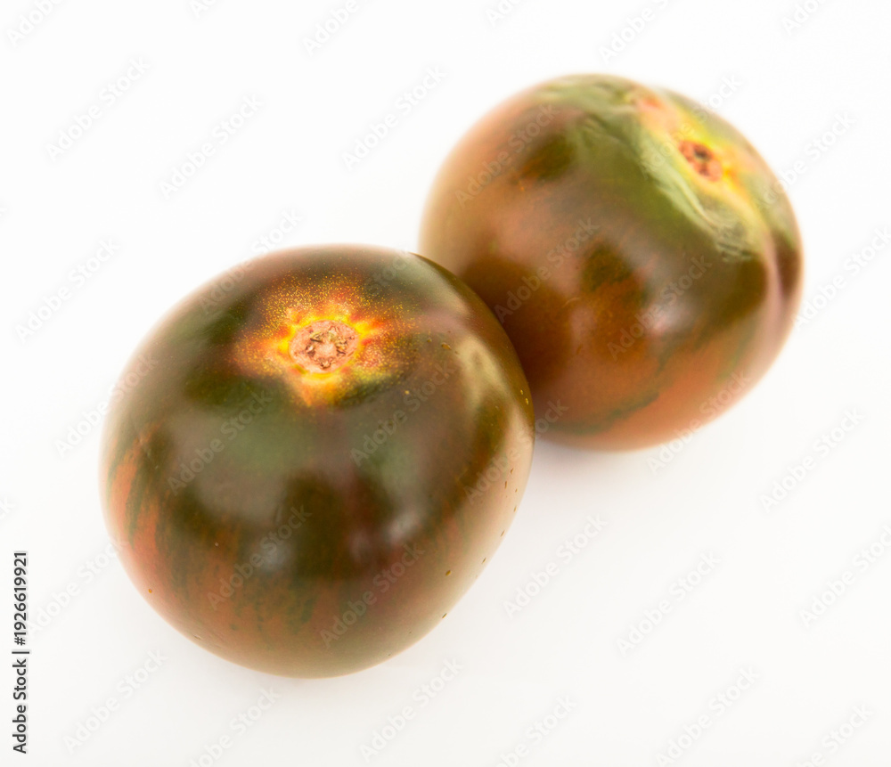 Fototapeta premium ripe black tomatoes on a white background