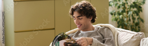 Fényképezés Enjoying a quiet afternoon reading at home in a cozy apartment