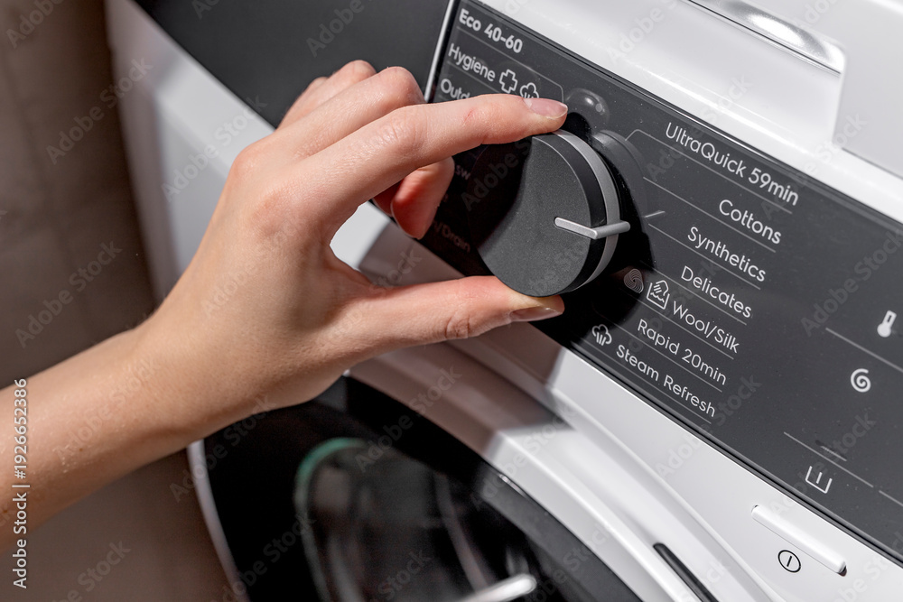 custom made wallpaper toronto digitalWoman selecting washing machine wash program on control panel. Adult female hand turning front loading appliance dial. Domestic laundry concept for home, cleaning, household lifestyle..