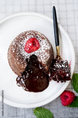Homemade Chocolate molten lava cake served with raspberries and powdered sugar