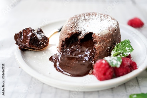 Homemade Chocolate molten lava cake served with raspberries and powdered sugar