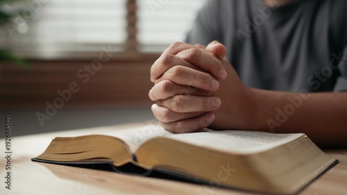 Wallpaper Mural Hands clasped prayer with Holy Bible for Christian faith, spirituality, worship, devotion, hope, and religious belief, prayer time in church, trust in God, and spiritual guidance. Torontodigital.ca