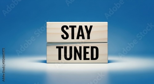STAY TUNED message written on wooden blocks over blue background