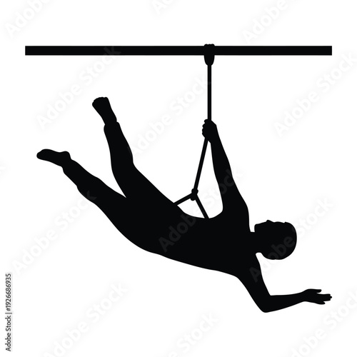 Silhouette of a person hanging from a gymnastics bar using straps