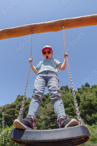 Girl playing on the swing