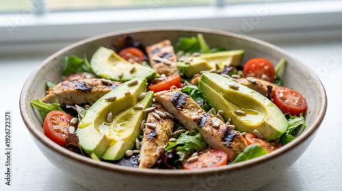 Wallpaper Mural Close up of fresh salad with grilled chicken strips, avocado slices, cherry tomatoes, mixed greens, sunflower seeds, olive oil drizzle Torontodigital.ca