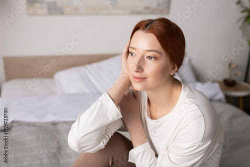 Young woman with red hair enjoys a peaceful moment in her cozy modern apartment Free Download Young woman with red hair enjoys a peaceful moment in her cozy modern apartment - GFXLoad