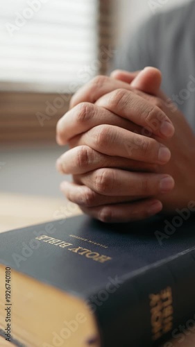 Wallpaper Mural Hands clasped prayer with Holy Bible for Christian faith, spirituality, worship, devotion, hope, and religious belief, prayer time in church, trust in God, and spiritual guidance. Torontodigital.ca