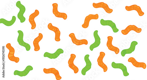 Multiple orange and green gummy worm candies are distributed in a random pattern across a solid white background area.