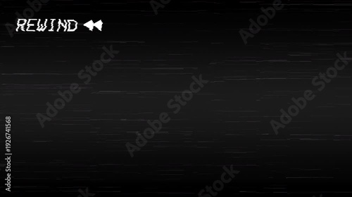 Rewind VHS with REWIND text, static interference, scratch effects, and screen artifacts on a black background. 4K video