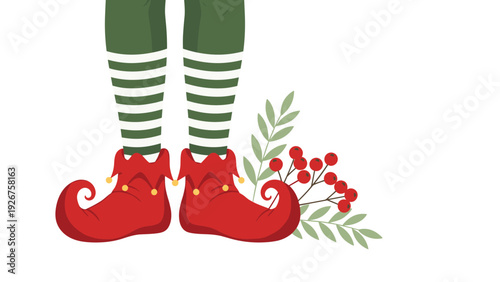 Christmas elf legs wearing green stockings and red pointed boots standing next to festive holly berries and leaves.