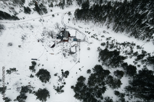 A view of a snow-covered house, seen from a drone