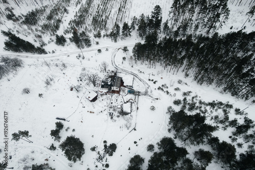 A view of a snow-covered house, seen from a drone