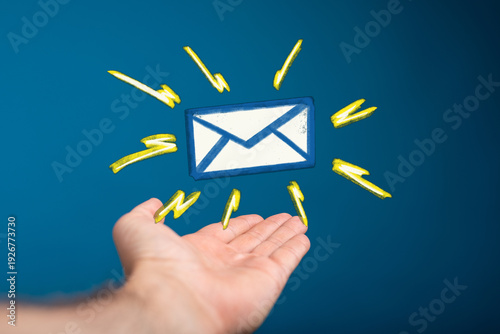 Hand holding email icon wit...