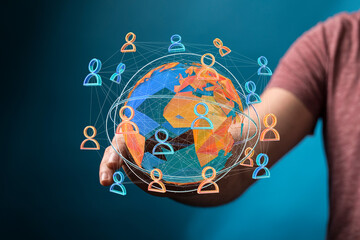 Concept of global connection, networking and community with world map and people icons in hand. Shows unity, collaborati
