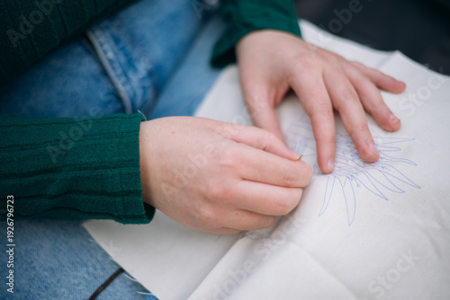 Fényképezés Woman embroidering fabric with needle and thread