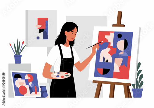 Creative young woman artist painting abstract modern art on a canvas in her studio, holding a paintbrush and color palette.