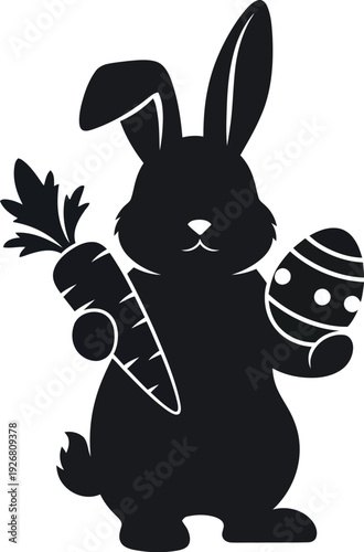 Easter bunny holding carrot and decorated egg