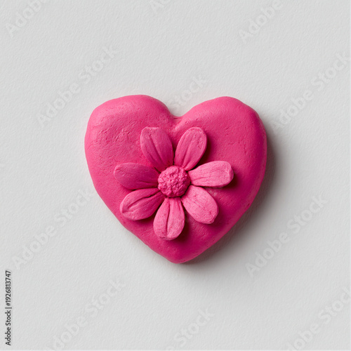 pink heart with flower made from Plasticine clay, on white plain clear background