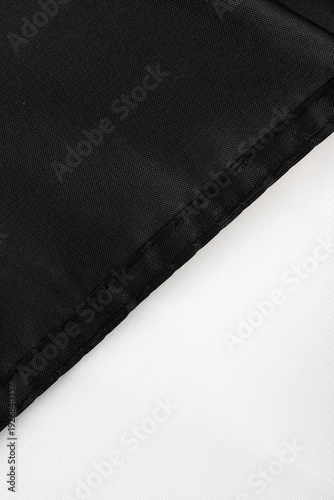 Seams on nylon fabric with stitches. Synthetic fabric texture. Macro detail.