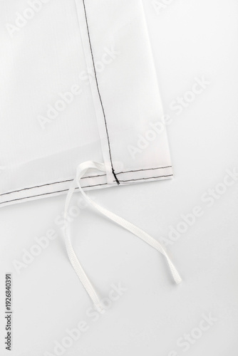 Seams on nylon fabric with stitches. Synthetic fabric texture. Macro detail.