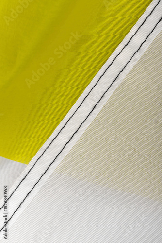 Seams on nylon fabric with stitches. Synthetic fabric texture. Macro detail.