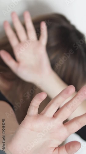 Violent man attacking woman, showing conflict and oppression. Dramatic scene of abuse and intimidation. Footage emphasizes stop violence message. Vertical video.