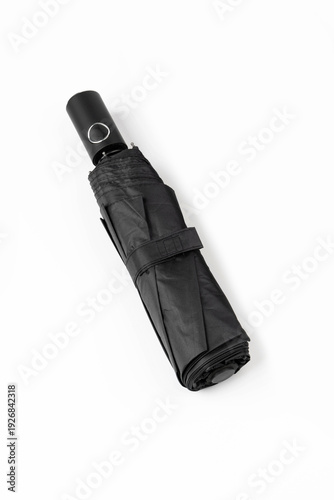Folded black automatic umbrella isolated on white background