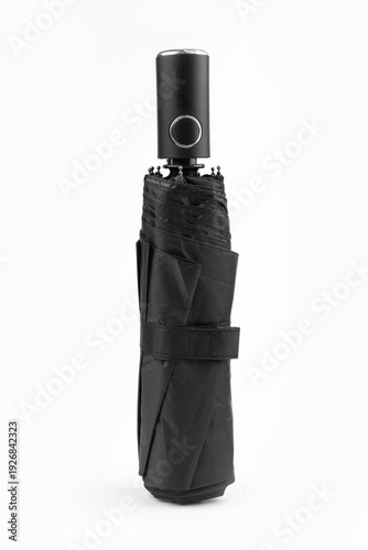 Folded black automatic umbrella isolated on white background