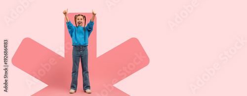Tableau sur toile A girl stands in a playful pose, raising her arms with excitement