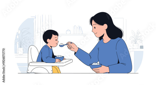 Caring mother feeding her young son a healthy meal while he sits in a white baby high chair at home in the dining room.