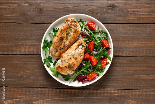 Roasted chicken breast and vegetable salad on plate
