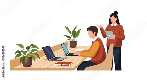 Two people working together at a desk with laptops.