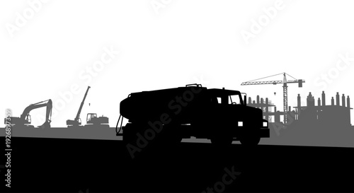 Silhouette of heavy construction equipment and urban development.