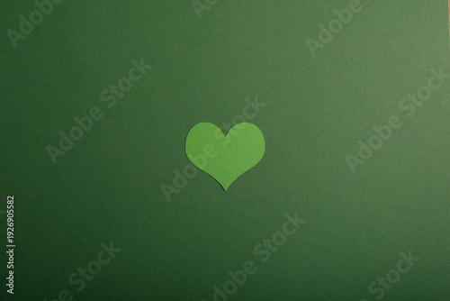 A single green paper heart ...